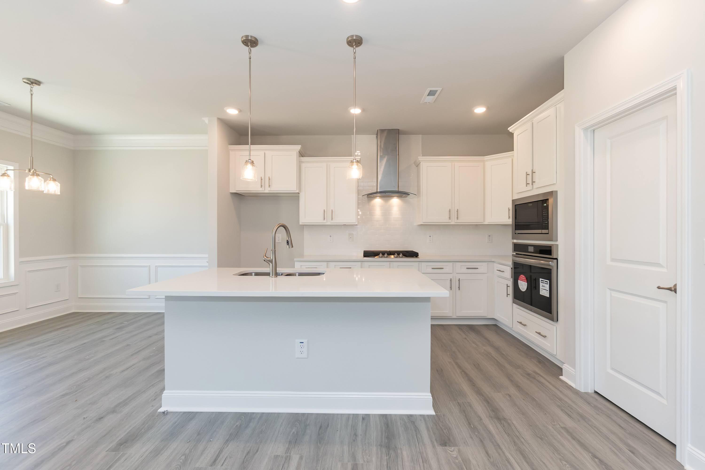 56 Braddock Court Garner, NC 27529 - Photo 10 of 55 a large kitchen with cabinets and wooden floor