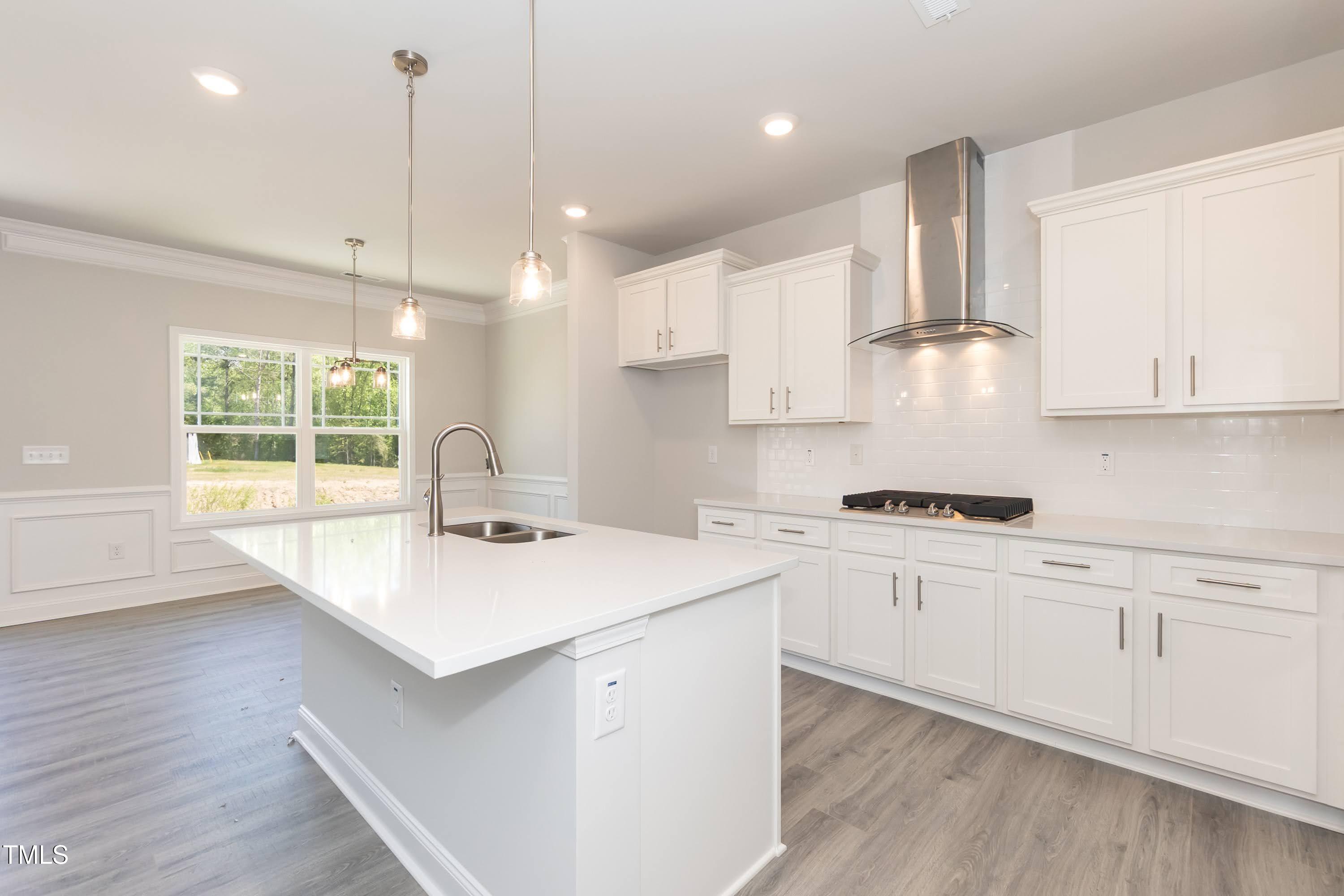 56 Braddock Court Garner, NC 27529 - Photo 11 of 55 a kitchen with a sink a stove a refrigerator and white cabinets