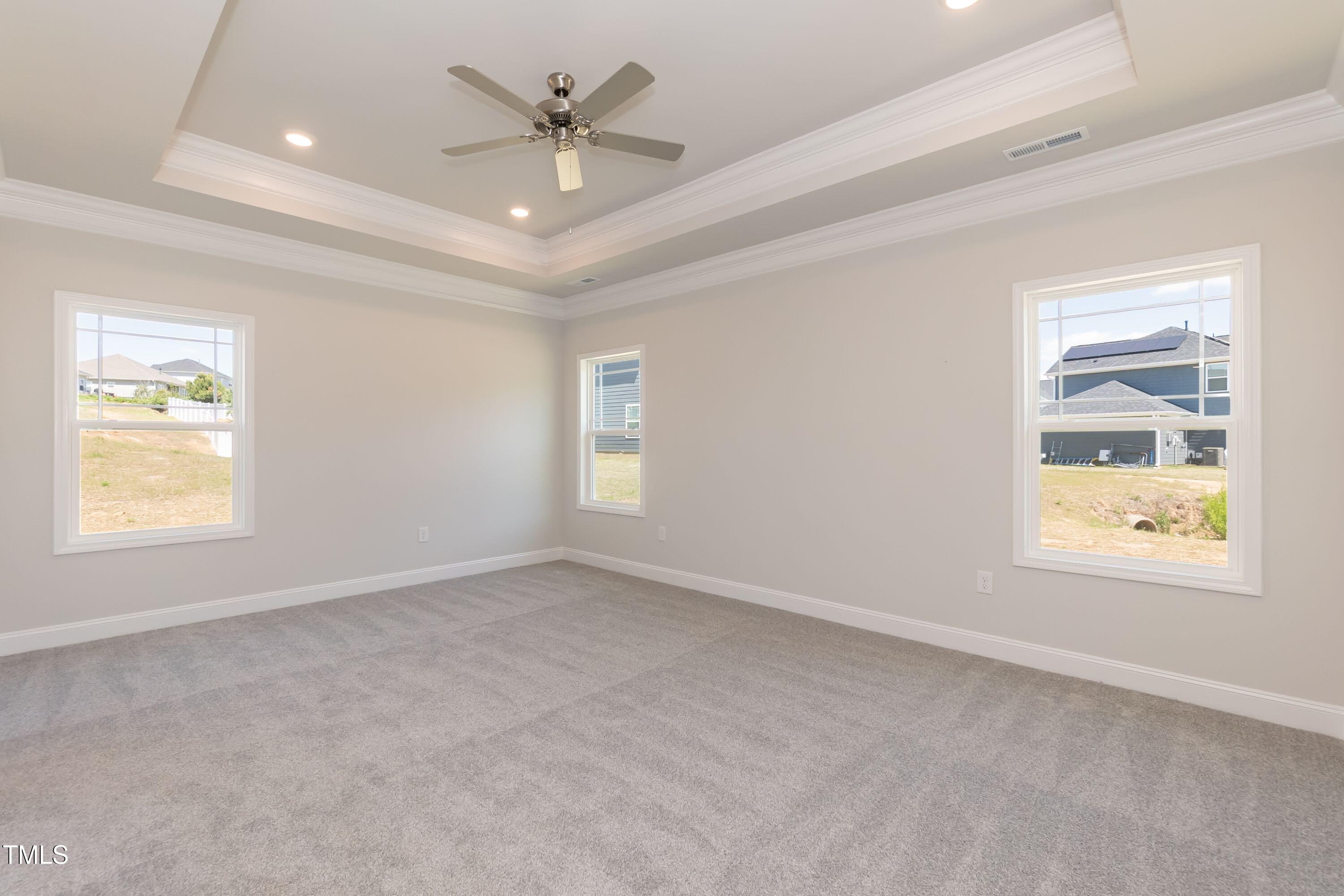 56 Braddock Court Garner, NC 27529 - Photo 19 of 55 an empty room with windows and fan