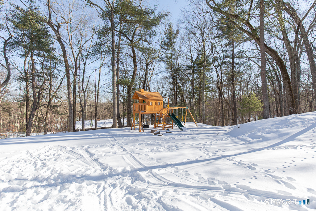 34 Milan Road Woodbridge, CT 06525 - Photo 32 of 40 The back yard play area has a play structure which does not convey with the property.