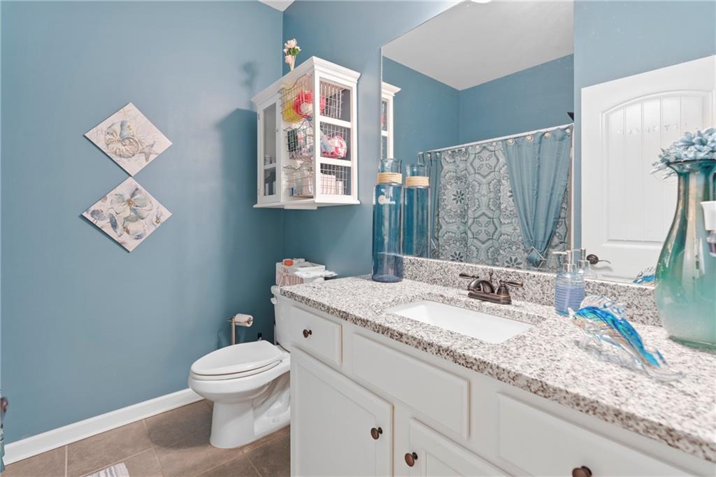 420 Andrew Ridge Drive Jefferson, GA 30549 - Photo 20 of 26 a bathroom with a granite countertop toilet sink and mirror