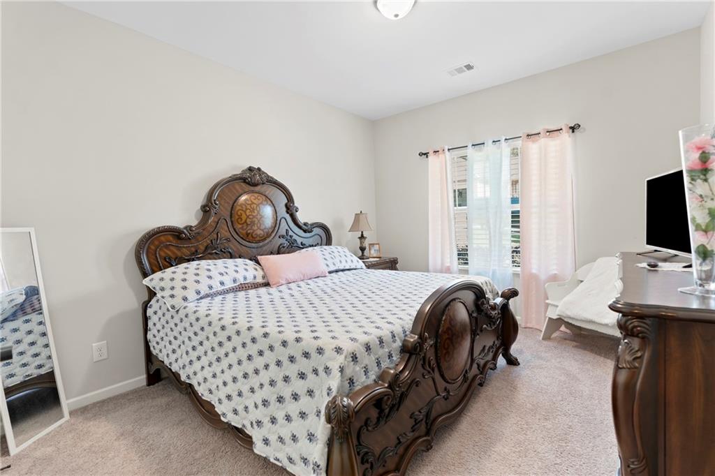 420 Andrew Ridge Drive Jefferson, GA 30549 - Photo 21 of 26 a bedroom with a bed and a flat screen tv