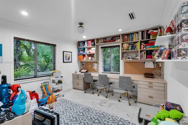 a room with furniture a rug toys and a window