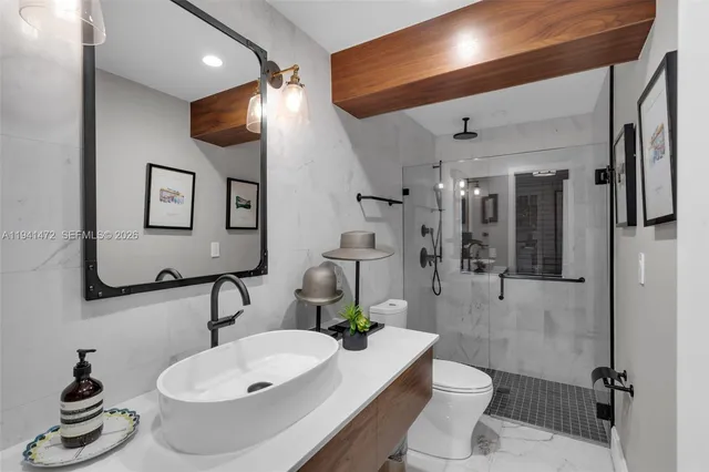 a bathroom with a sink toilet and shower