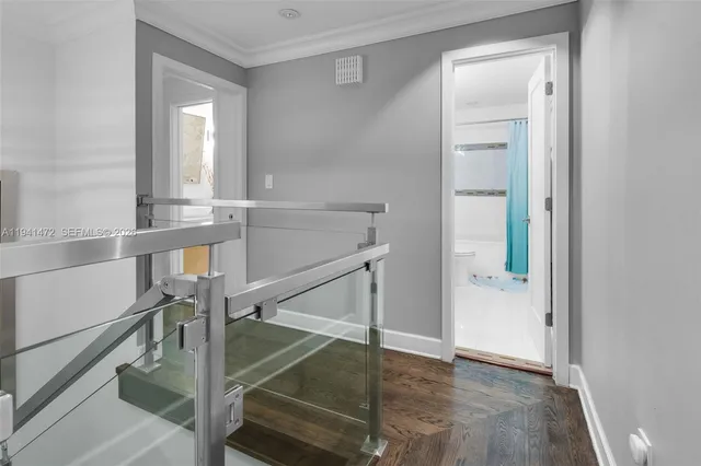 a view of entryway and hall with wooden floor