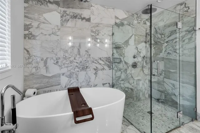 a bathroom with a bathtub and shower