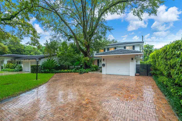 a front view of a house with a yard and a garage