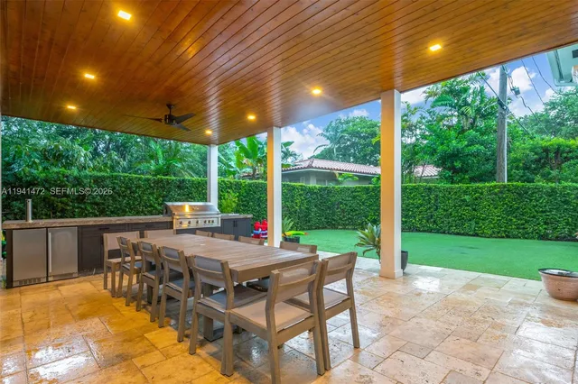 a view of a patio with a dining table and chairs