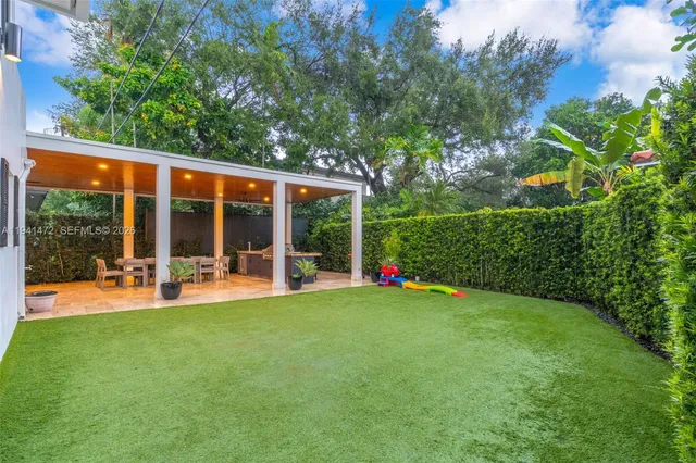 a view of a house with backyard sitting area and garden