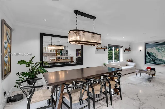 a kitchen with granite countertop a table and chairs in it