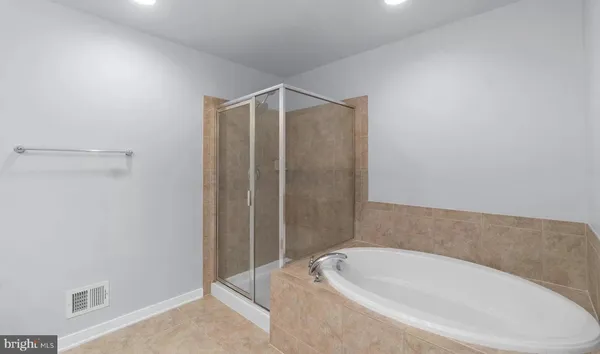 a bathroom with a bathtub and shower