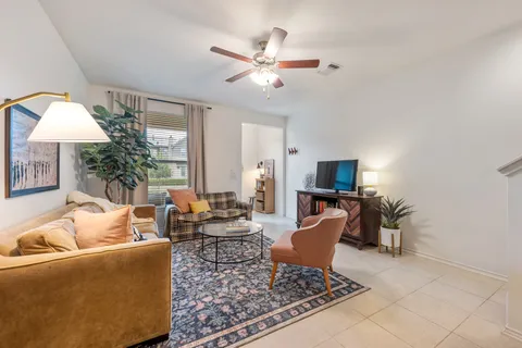 a living room with furniture and a chandelier