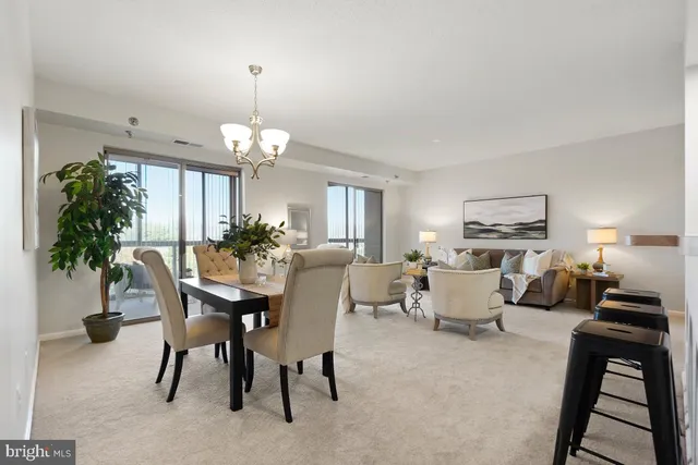 a view of a dining room with furniture and a potted plant