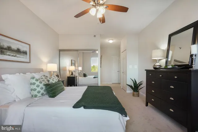 a bedroom with a bed and ceiling fan