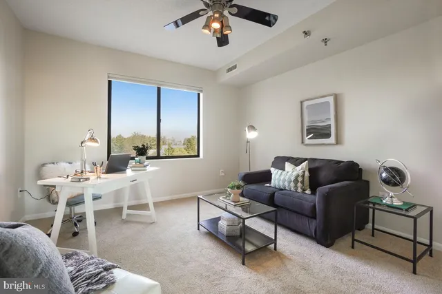 a living room with furniture a chandelier and a window