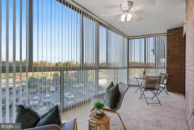 a living room with furniture and a floor to ceiling window
