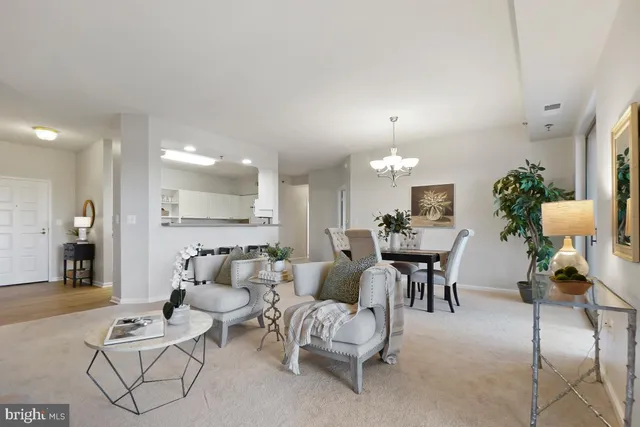 a living room with furniture and a chandelier