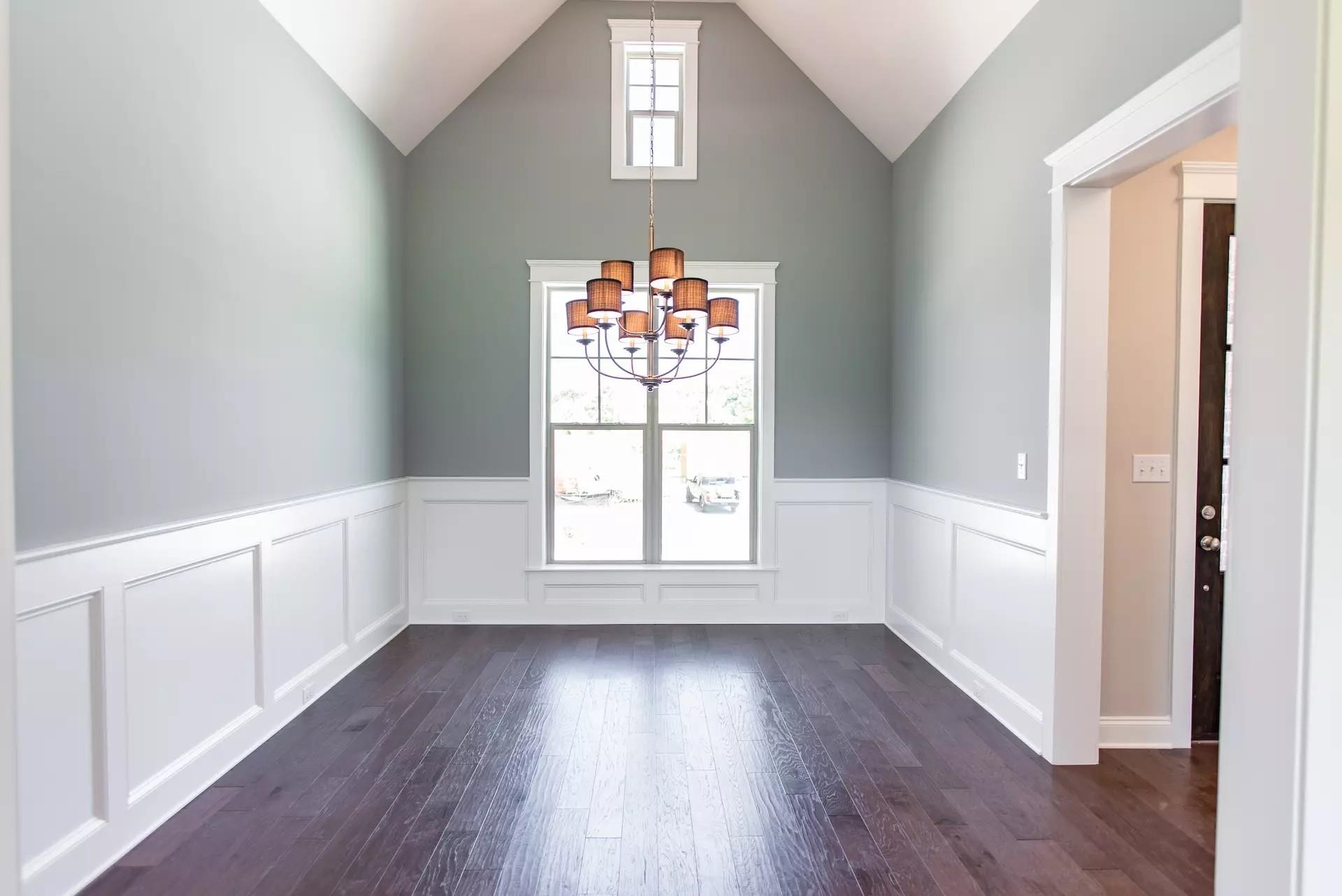 6288 Howie Way Pace, FL 32571 - Photo 15 of 27 an empty room with wooden floor and windows