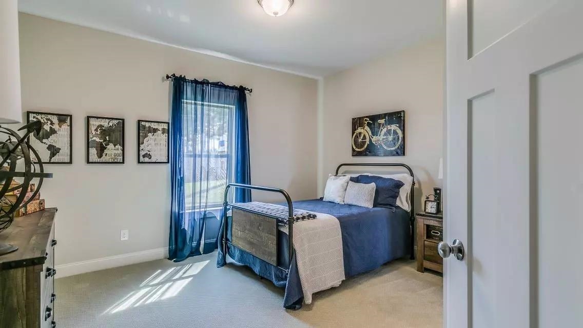 6288 Howie Way Pace, FL 32571 - Photo 7 of 27 a bed room with a bed and a window