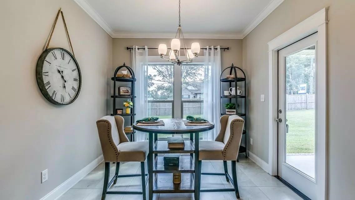 6288 Howie Way Pace, FL 32571 - Photo 9 of 27 a dining room with furniture a large window and a clock