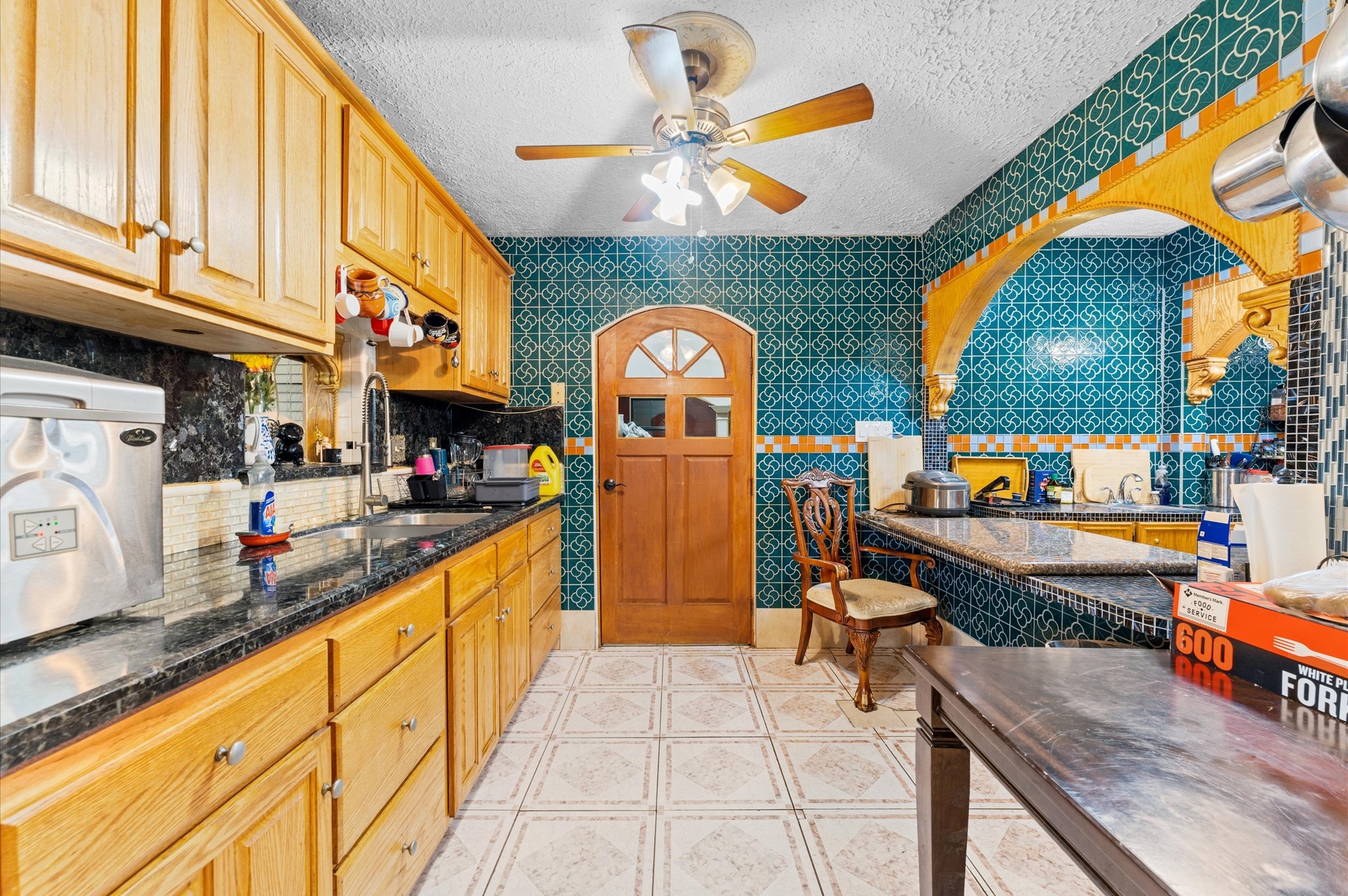 707 Doncrest Street Channelview, TX 77530 - Photo 14 of 27 a kitchen with stainless steel appliances granite countertop a stove a sink and a dining table chair