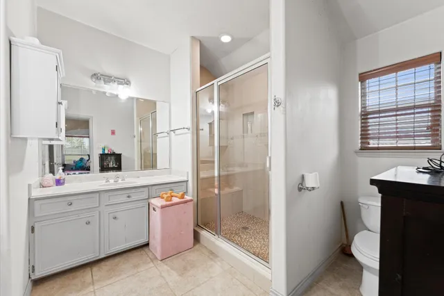 a bathroom with a double vanity sink toilet mirror and bathtub