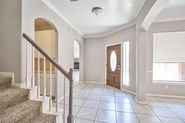 a view of an entryway with wooden floor and door