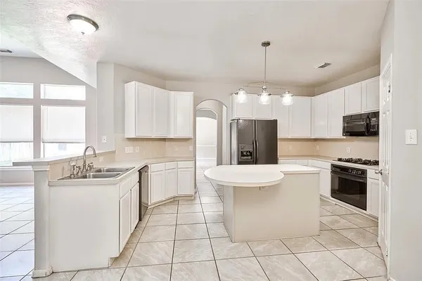 a kitchen with a sink stove and refrigerator