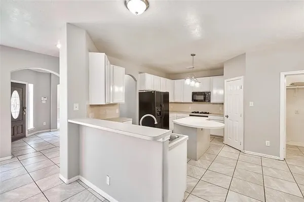 a kitchen with stainless steel appliances a refrigerator sink and cabinets