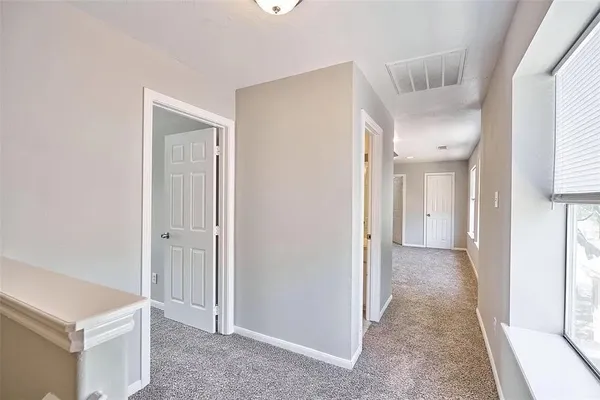 a view of hallway with a large mirror and a shower