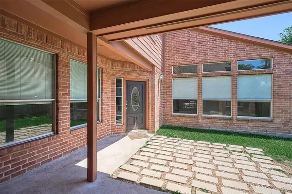 a view of a brick house with a large windows
