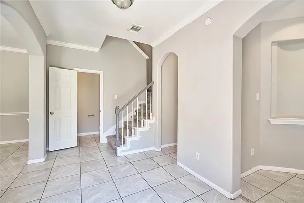 a view of entryway with stairs and a chandelier