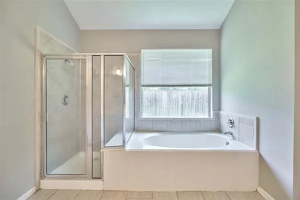 a bathroom with a bathtub and shower