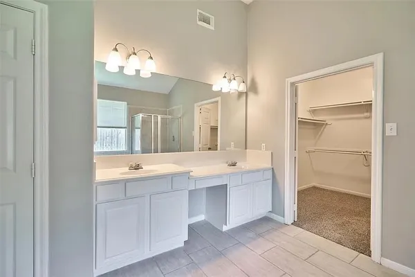 a bathroom with a granite countertop sink a large mirror and a bathtub