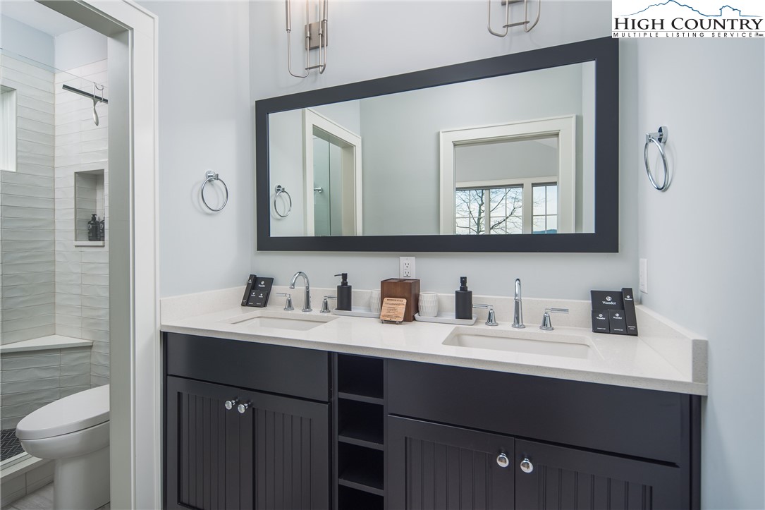 227 Calico Court Boone, NC 28607 - Photo 23 of 47 a bathroom with a toilet sink and mirror