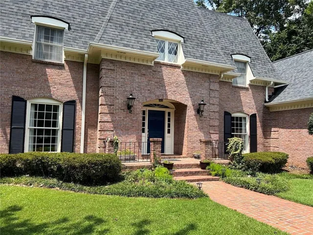 a front view of a house with garden