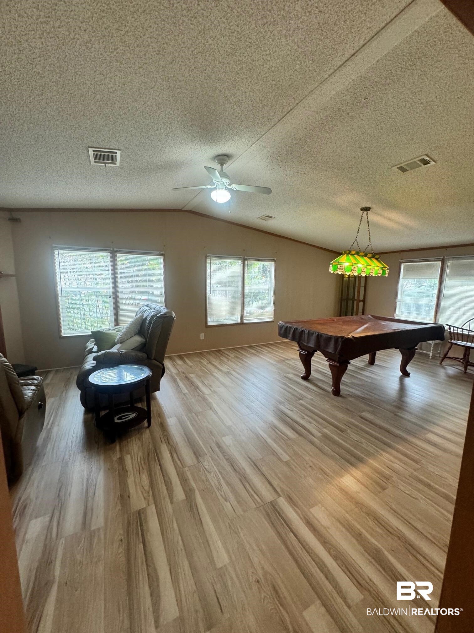 1862 Princess Lane Lillian, AL 36549 - Photo 12 of 41 Game room featuring a wealth of natural light, a textured ceiling, and light hardwood / wood-style floors