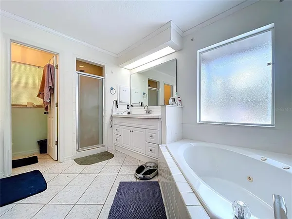 a bathroom with a tub sink and a mirror