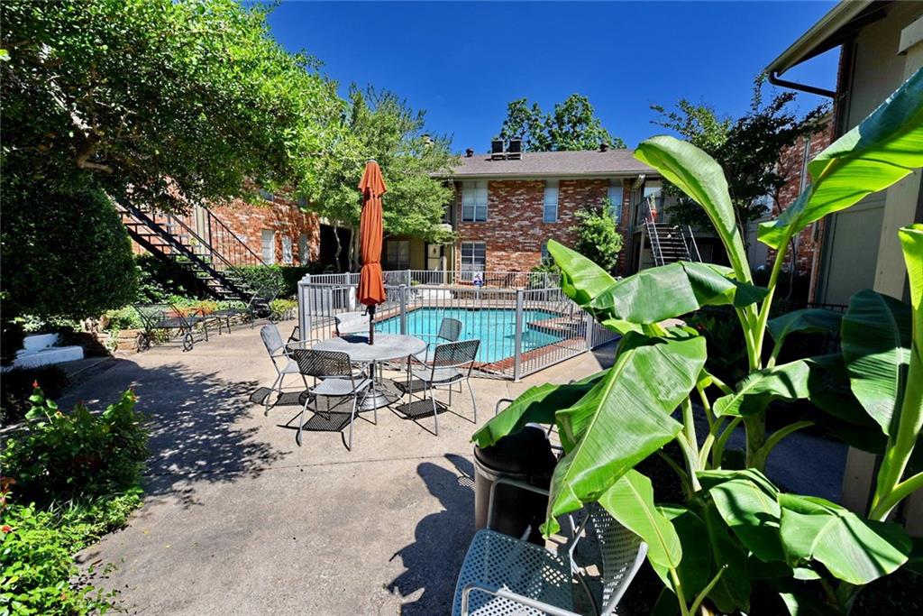 a view of a patio with table and chairs and a flower pot