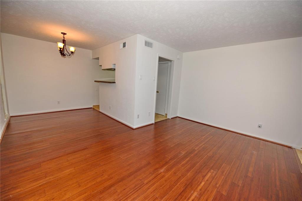 4317 Hartford Street, Unit 107 Dallas, TX 75219 - Photo 13 of 17 a view of empty room with wooden floor