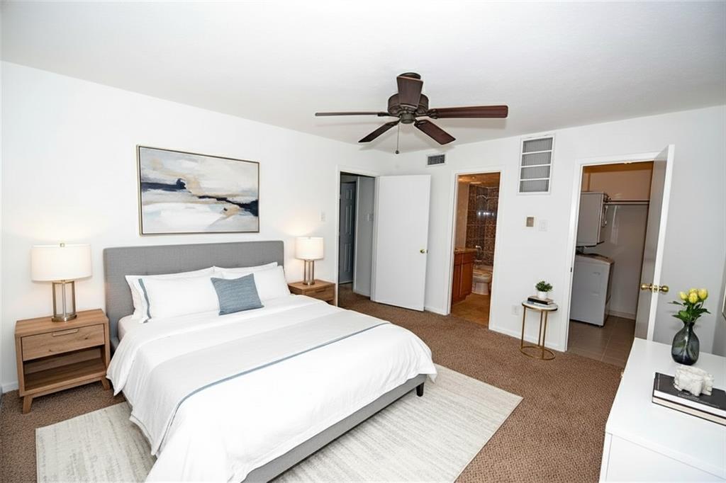 4317 Hartford Street, Unit 107 Dallas, TX 75219 - Photo 15 of 17 a bedroom with a bed and a mirror on the dresser