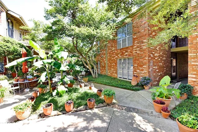 a bunch of flowers in front of brick building