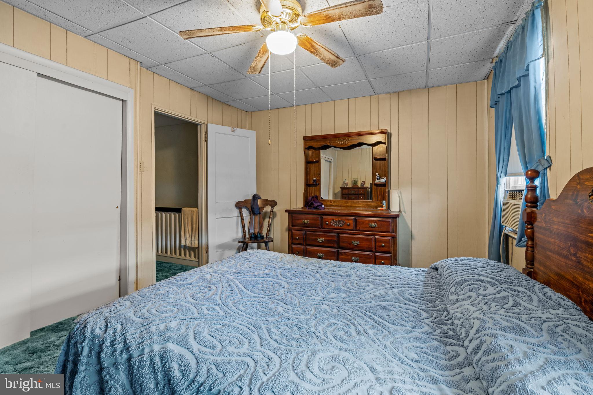 6520 Marsden Street Philadelphia, PA 19135 - Photo 16 of 26 a bedroom with a bed and a chandelier
