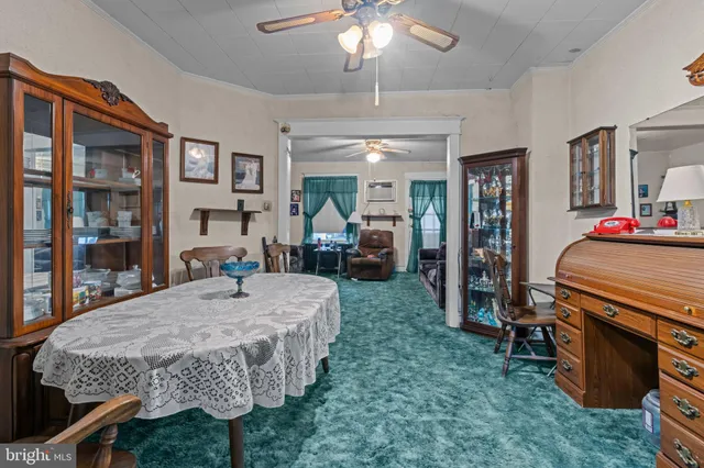 a bed room with a bed table and a chandelier