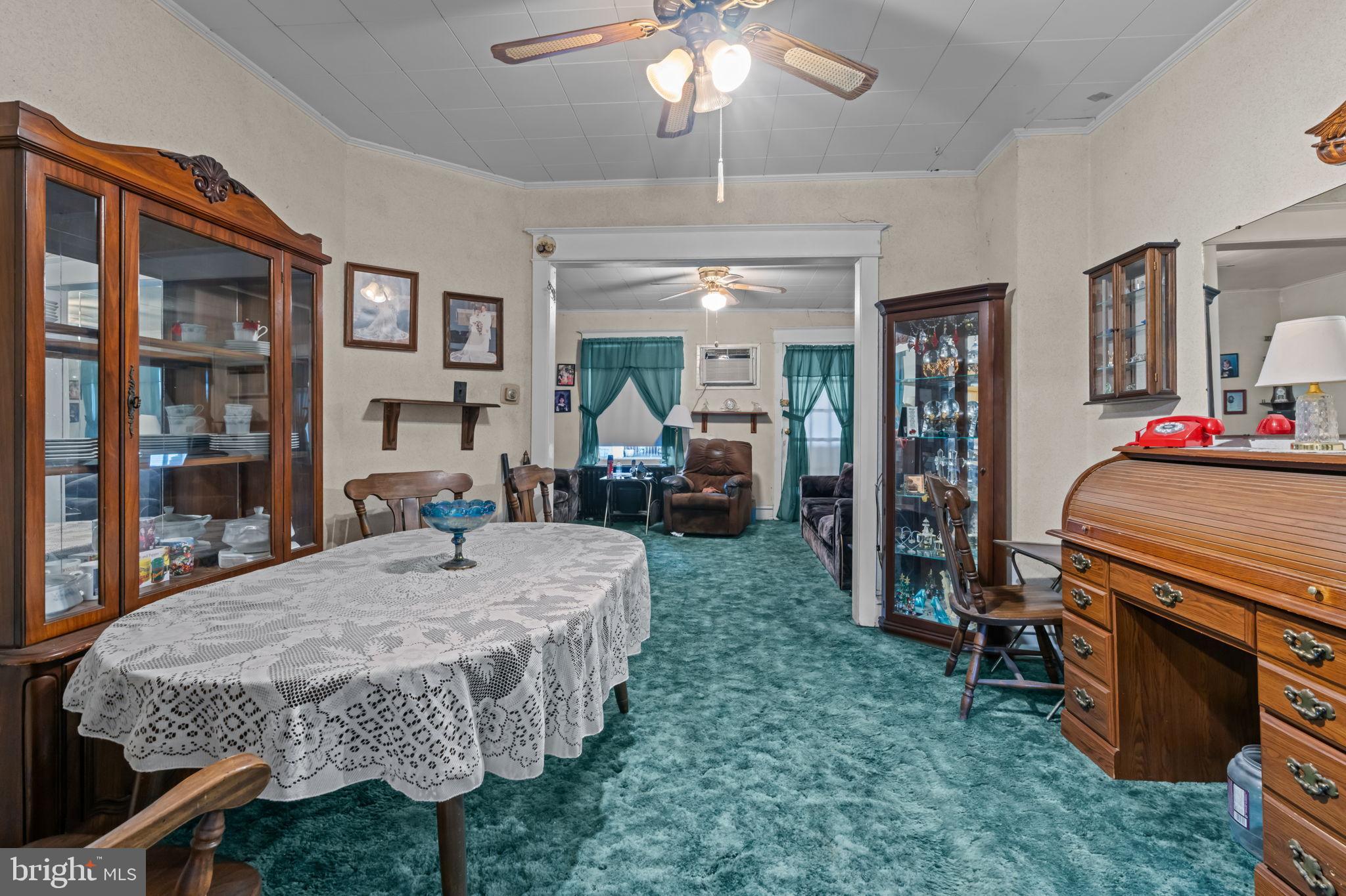 6520 Marsden Street Philadelphia, PA 19135 - Photo 9 of 26 a bed room with a bed table and a chandelier