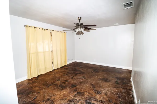 a view of a hallway with a chandelier fan