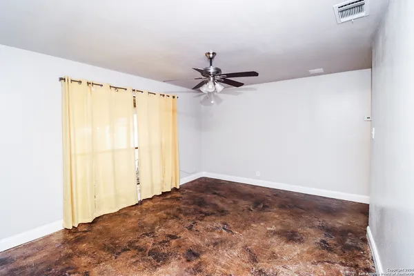 wooden floor in an empty room with a mirror