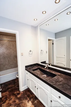 a bathroom with a toilet and a bath tub