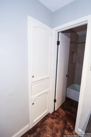 an empty room with chandelier fan