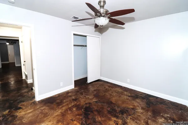a view of empty room with ceiling fan